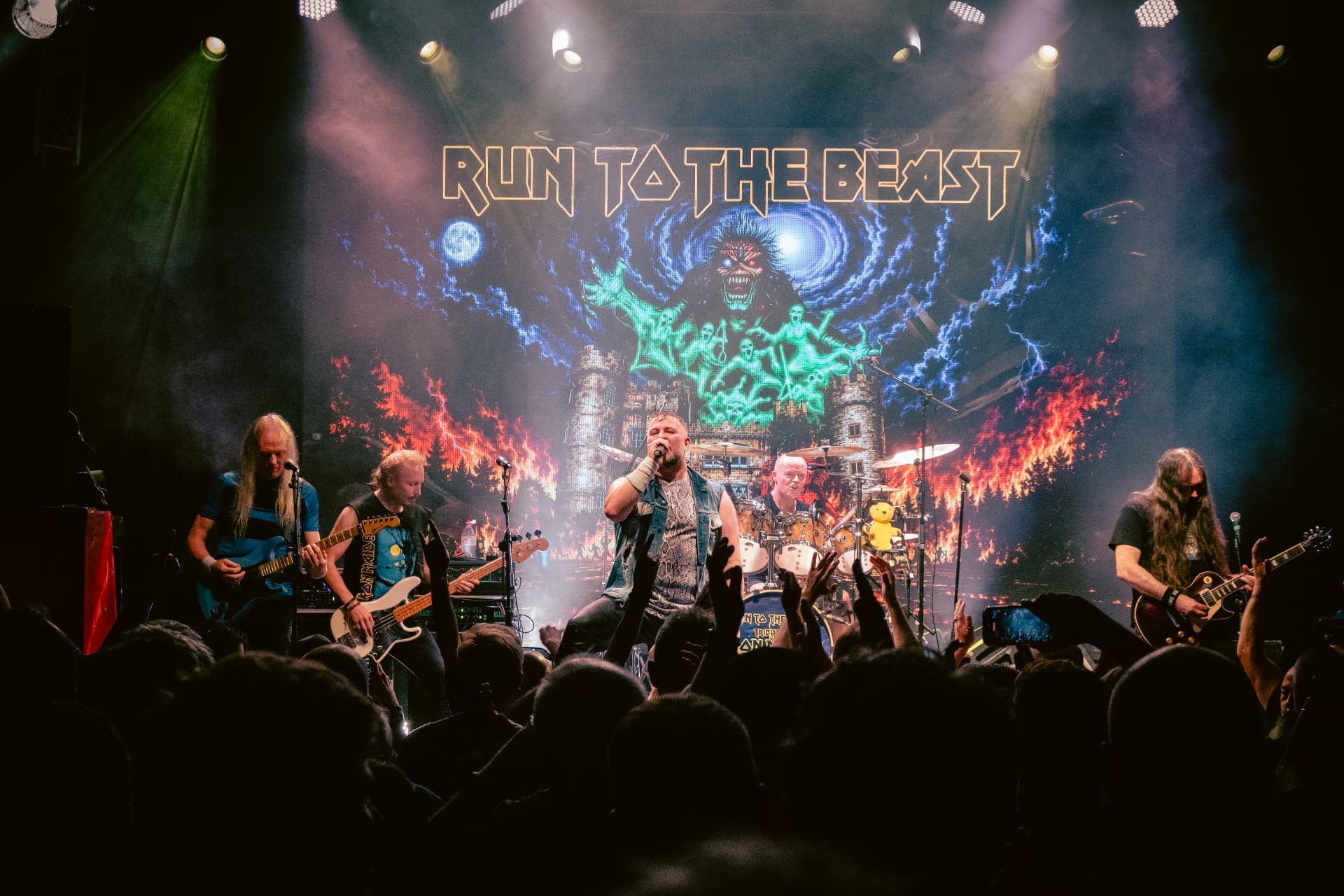 Run to the Beast performing at The Button Factory, Dublin — the vocalist leading the crowd with hands in the air